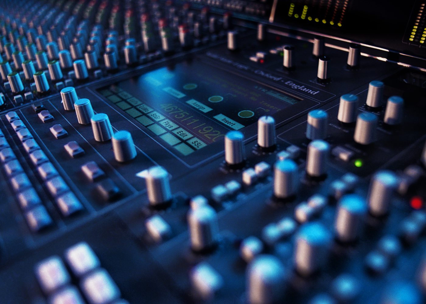 Close up of the SSL mixing desk under blue studio lighting